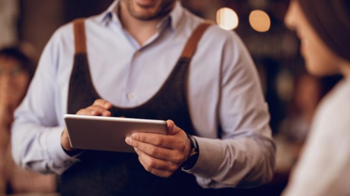 closeup waiter taking order touchpad while talking guest pub 637285 2460