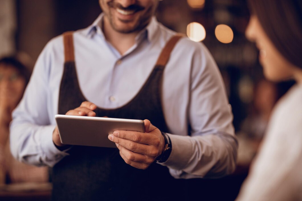 closeup waiter taking order touchpad while talking guest pub 637285 2460